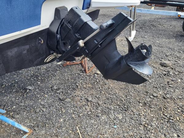 Slide: The Image of 2006 Bayliner 192 Discovery boat propeller and outdrive on gravel surface. - 18