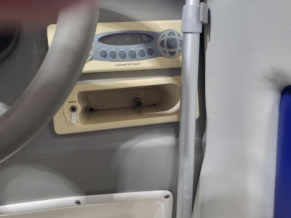 Slide: The Image of 2006 Bayliner 192 Discovery boat dashboard with stereo system and steering wheel. - 21