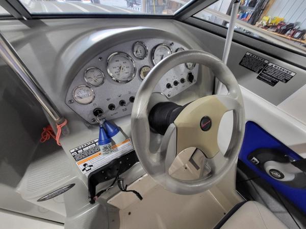 Slide: The Image of 2006 Bayliner 192 Discovery boat dashboard with steering wheel and instrument panel. - 4