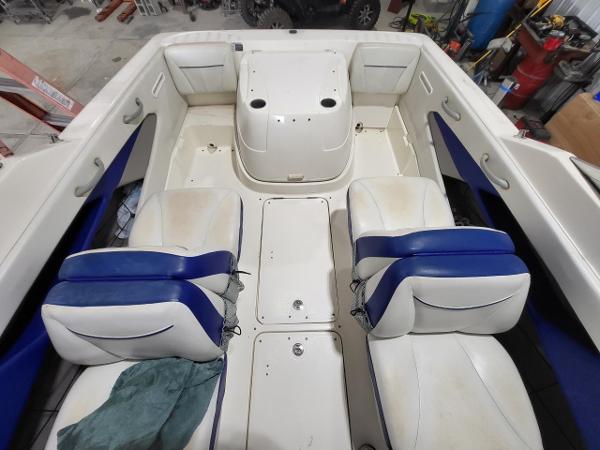 Slide: The Image of 2006 Bayliner 192 Discovery boat interior with white and blue seating. - 9