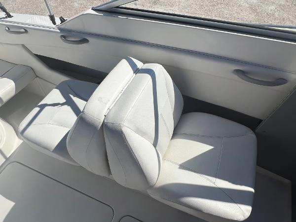 Slide: The Image of 2012 Bayliner 192 Discovery boat interior with white cushioned seats. - 23