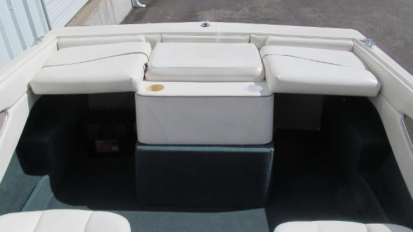 Slide: The Image of 2000 Bayliner 1950 Capri DX boat interior with white seating and cup holders. - 12