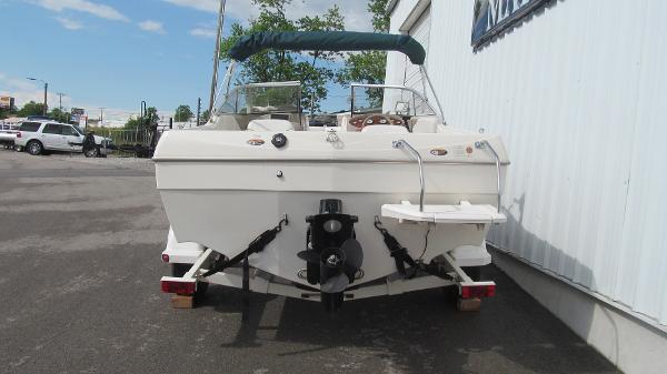 Slide: The Image of Bayliner 1950 Capri DX 2000 boat, rear view, parked outdoors. - 3