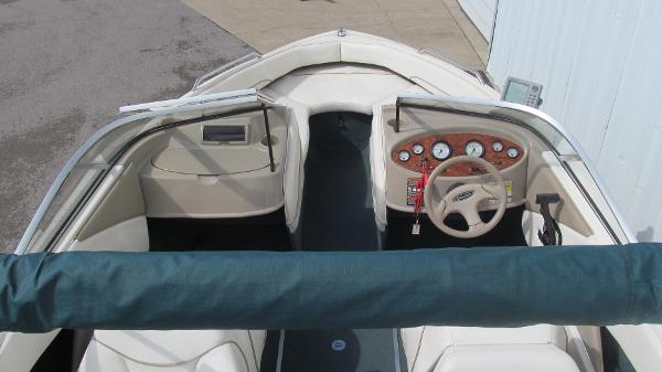 Slide: The Image of 2000 Bayliner 1950 Capri DX boat interior with steering wheel and dashboard controls. - 5
