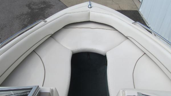 Slide: The Image of 2000 Bayliner 1950 Capri DX boat interior with white cushioned seating. - 8