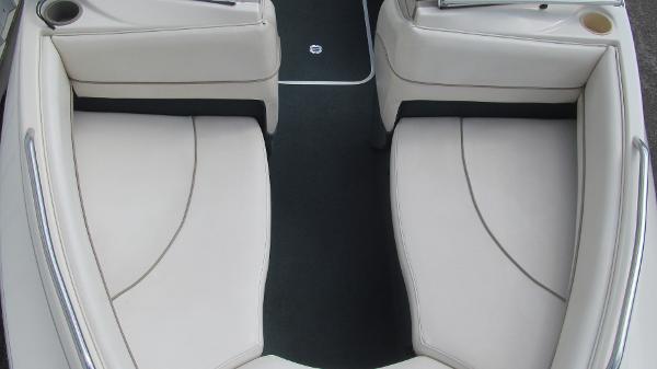 Slide: The Image of Interior seating of 2000 Bayliner 1950 Capri DX boat, featuring white cushioned seats. - 9