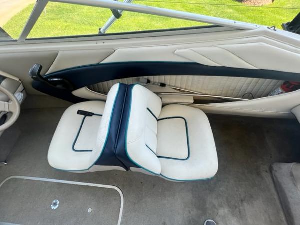 Slide: The Image of Interior of a 1995 Bayliner 2050 Capri boat with white and black seating. - 13
