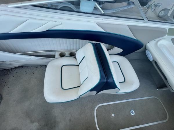 Slide: The Image of 1995 Bayliner 2050 Capri boat interior with white and blue seating. - 14