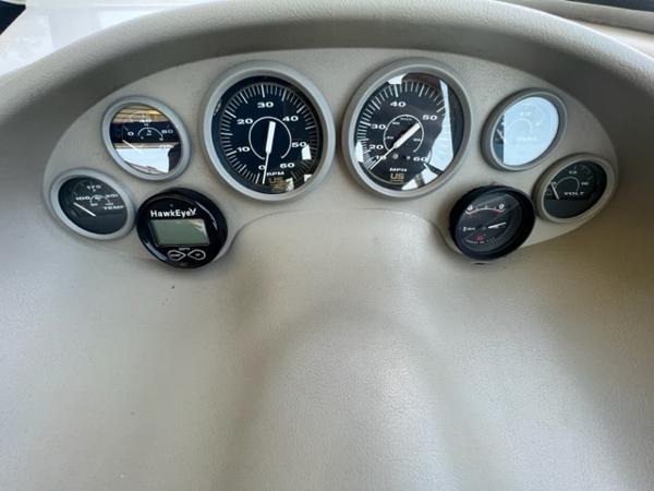 Slide: The Image of Dashboard of a 1995 Bayliner 2050 Capri boat with various gauges and instruments. - 5
