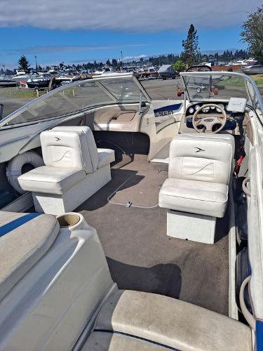 Slide: The Image of 2003 Bayliner 205 Olympic Edition boat interior with white seating and steering wheel. - 10