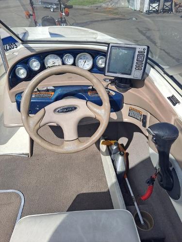 Slide: The Image of 2003 Bayliner 205 Olympic Edition boat dashboard with steering wheel and navigation system. - 12