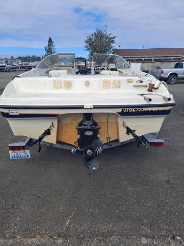 Slide: The Image of 2003 Bayliner 205 Olympic Edition boat, rear view, parked on asphalt. - 14