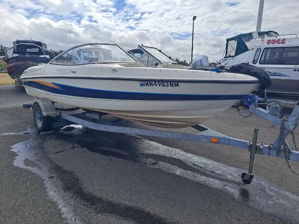 Slide: The Image of 2003 Bayliner 205 Olympic Edition boat on trailer, parked outdoors. - 15
