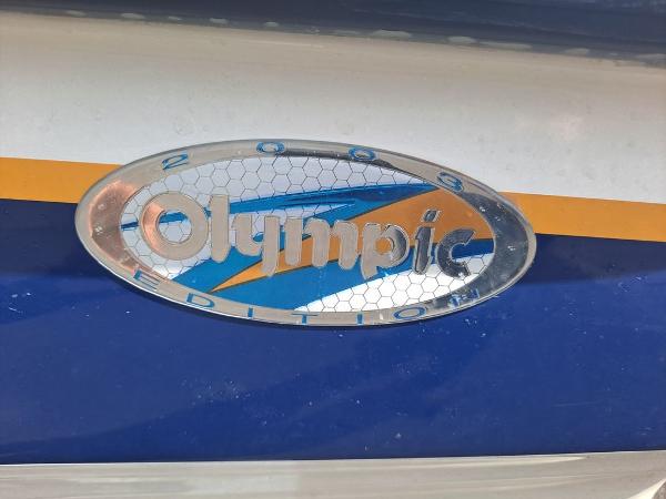 Slide: The Image of 2003 Bayliner 205 Olympic Edition logo on blue and orange background. - 2