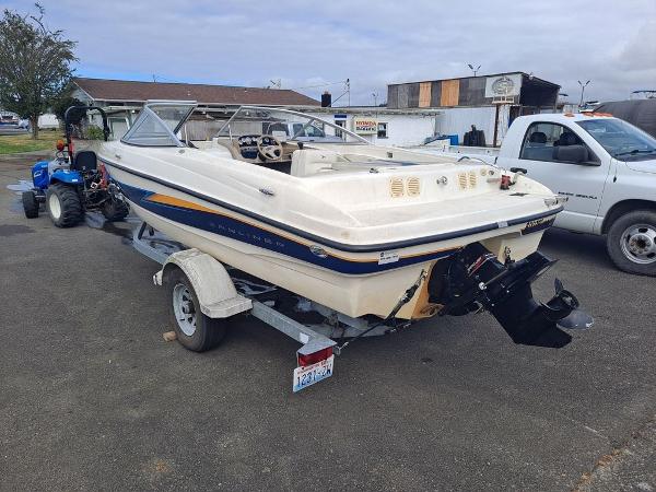 Slide: The Image of 2003 Bayliner 205 Olympic Edition boat on trailer in parking lot. - 3