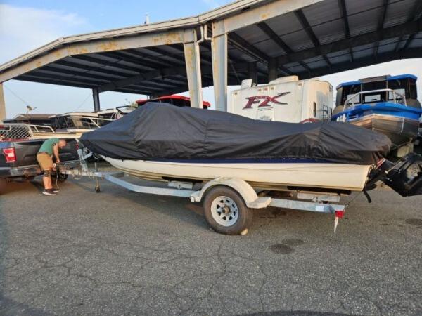 Slide: The Image of Covered 2003 Bayliner 205 Olympic Edition boat on trailer under shelter. - 6