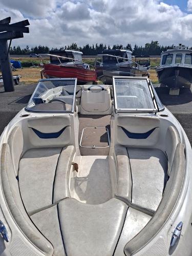Slide: The Image of 2003 Bayliner 205 Olympic Edition boat with open bow seating, parked outdoors. - 9