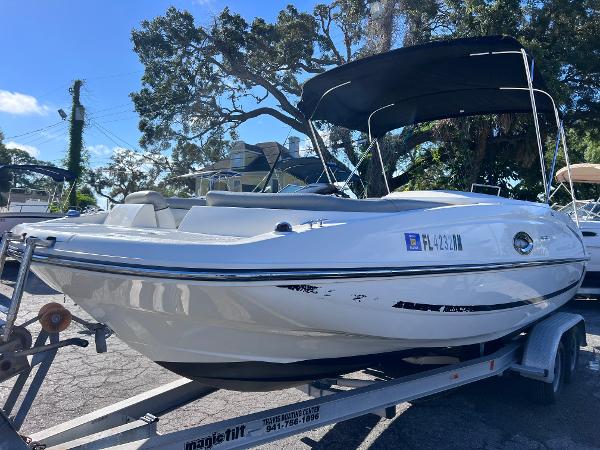 Slide: The Image of 2018 Bayliner 210 Deck Boat on trailer with black canopy. - 1