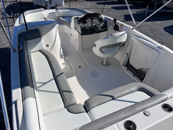 Slide: The Image of 2018 Bayliner 210 Deck Boat interior with seating and helm station. - 10