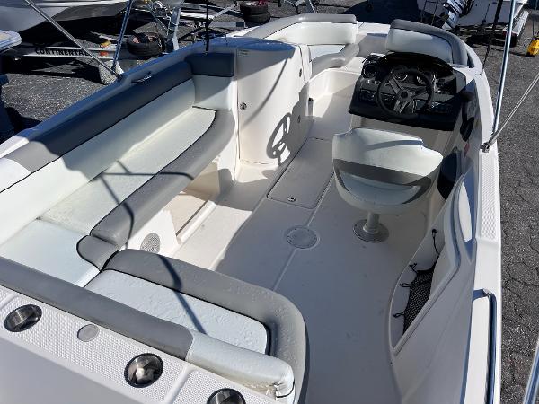 Slide: The Image of 2018 Bayliner 210 Deck Boat interior with seating and steering console. - 11