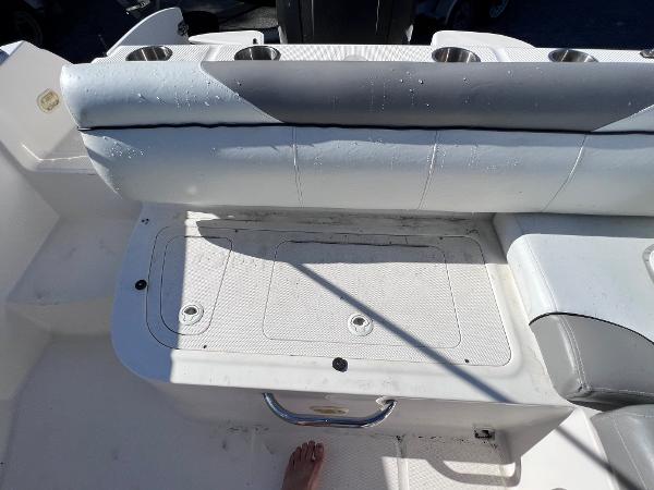 Slide: The Image of 2018 Bayliner 210 Deck Boat seating area with storage compartment. - 15