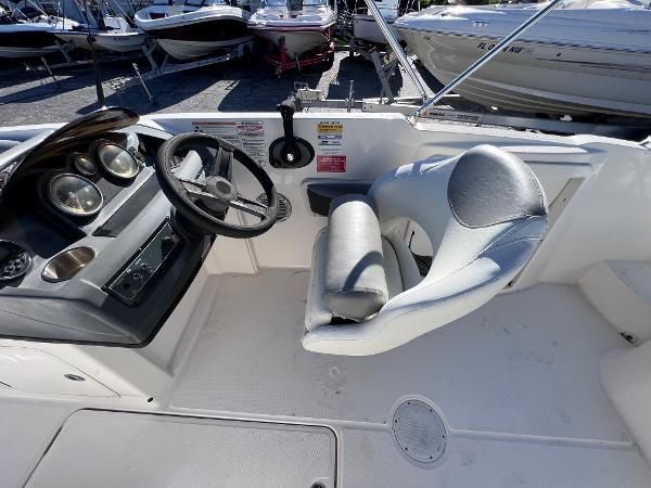 Slide: The Image of 2018 Bayliner 210 Deck Boat cockpit with steering wheel and captain's chair. - 19