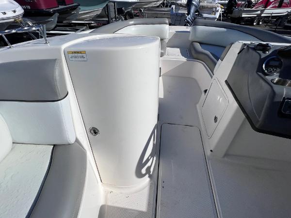 Slide: The Image of 2018 Bayliner 210 Deck Boat interior with seating and storage compartments. - 20