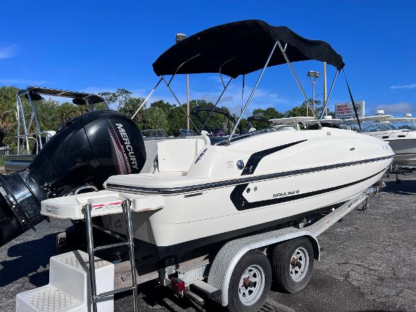 Slide: The Image of 2018 Bayliner 210 Deck Boat on trailer with Mercury outboard motor. - 3