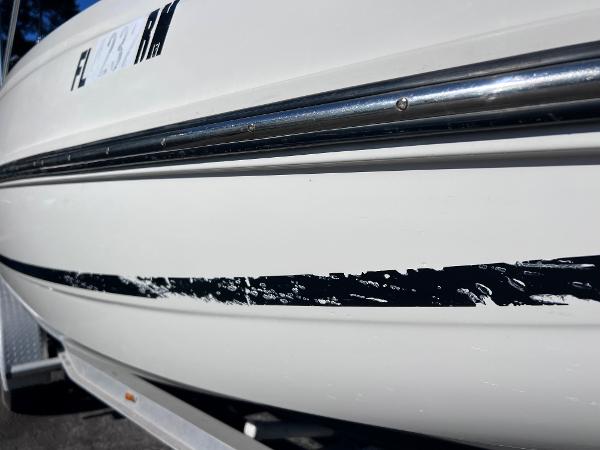 Slide: The Image of Close-up of a 2018 Bayliner 210 Deck Boat hull with visible scratches. - 5