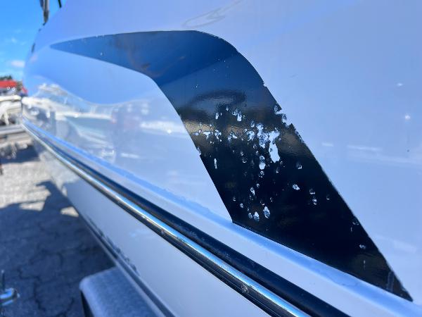 Slide: The Image of Close-up of 2018 Bayliner 210 Deck Boat with paint damage. - 6