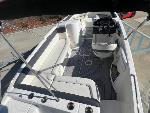 Slide: The Image of 2018 Bayliner 210 Deck Boat interior with spacious seating and modern helm. - 8