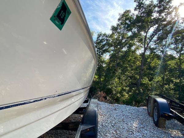 Slide: The Image of 2001 Bayliner 215 Bowrider boat on trailer, side view, outdoors. - 23