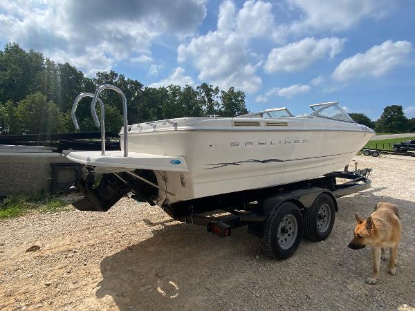 Slide: The Image of 2001 Bayliner 215 Bowrider on trailer with a dog nearby. - 30