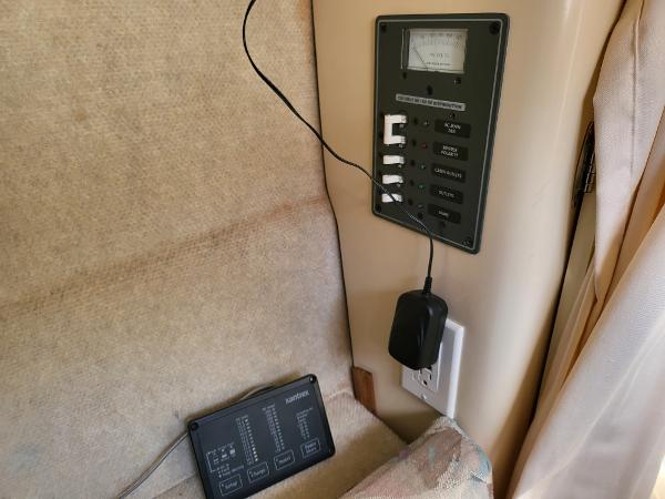Slide: The Image of Control panel and electrical outlet inside a 1995 Bayliner 2355 Ciera Sunbridge boat. - 15