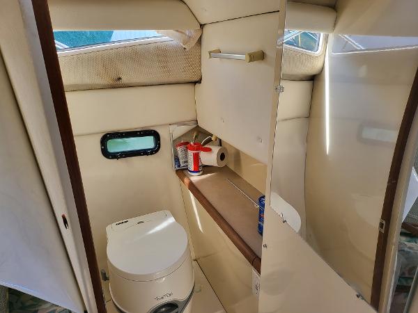 Slide: The Image of 1995 Bayliner 2355 Ciera Sunbridge boat interior bathroom with toilet and shelf. - 18