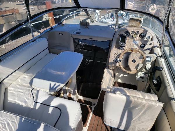 Slide: The Image of 1995 Bayliner 2355 Ciera Sunbridge interior with seating and helm. - 2