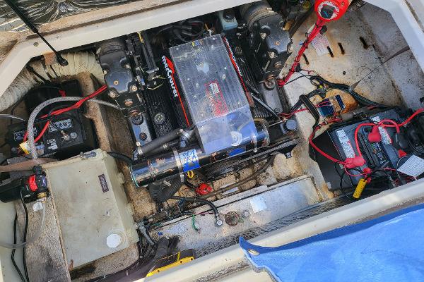 Slide: The Image of 1995 Bayliner 2355 Ciera Sunbridge engine compartment with MerCruiser engine and battery setup. - 20