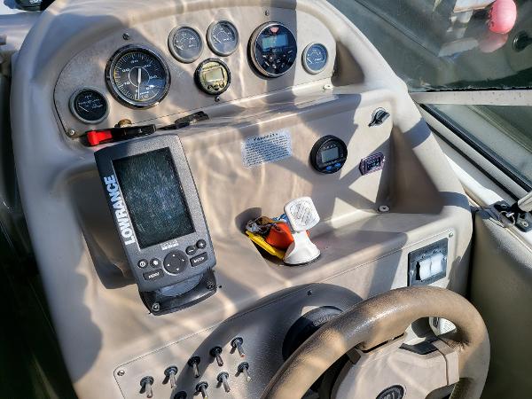 Slide: The Image of 1995 Bayliner 2355 Ciera Sunbridge dashboard with Lowrance fishfinder and gauges. - 3