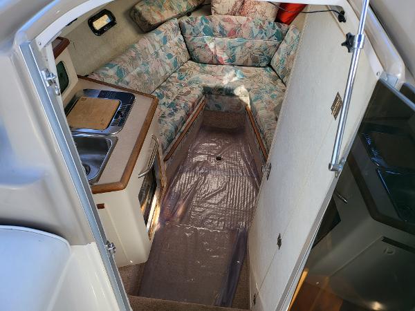 Slide: The Image of 1995 Bayliner 2355 Ciera Sunbridge cabin interior with kitchenette and seating area. - 5