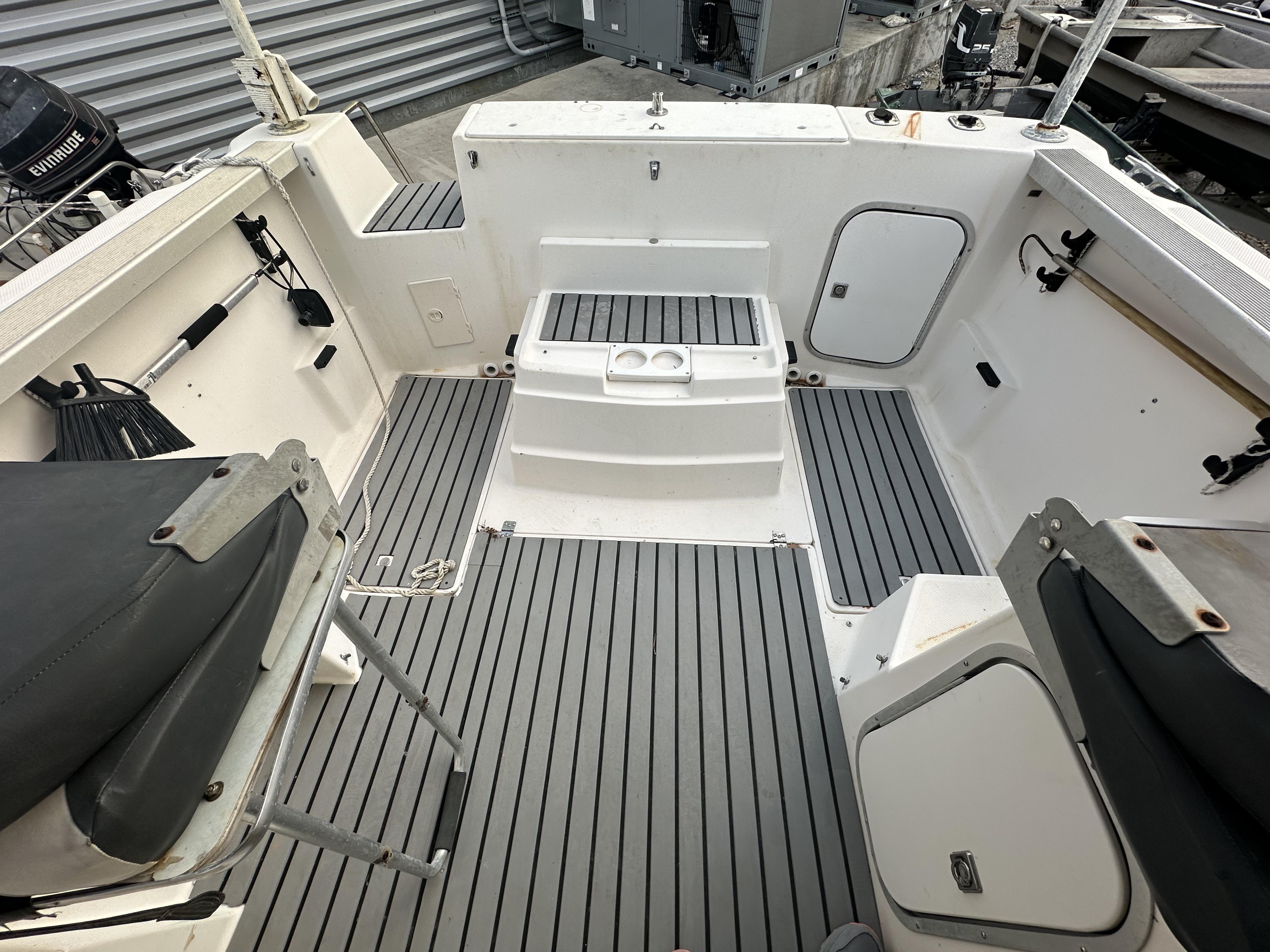 Slide: The Image of 1998 Bayliner 2452 Ciera Express boat interior with gray flooring and seating. - 12