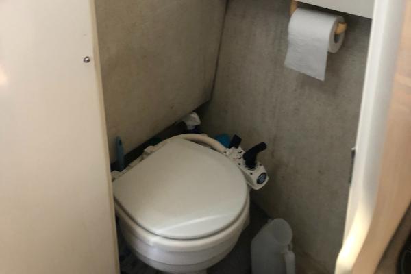 Slide: The Image of 1998 Bayliner 2452 Ciera Express boat bathroom with toilet and toilet paper holder. - 13