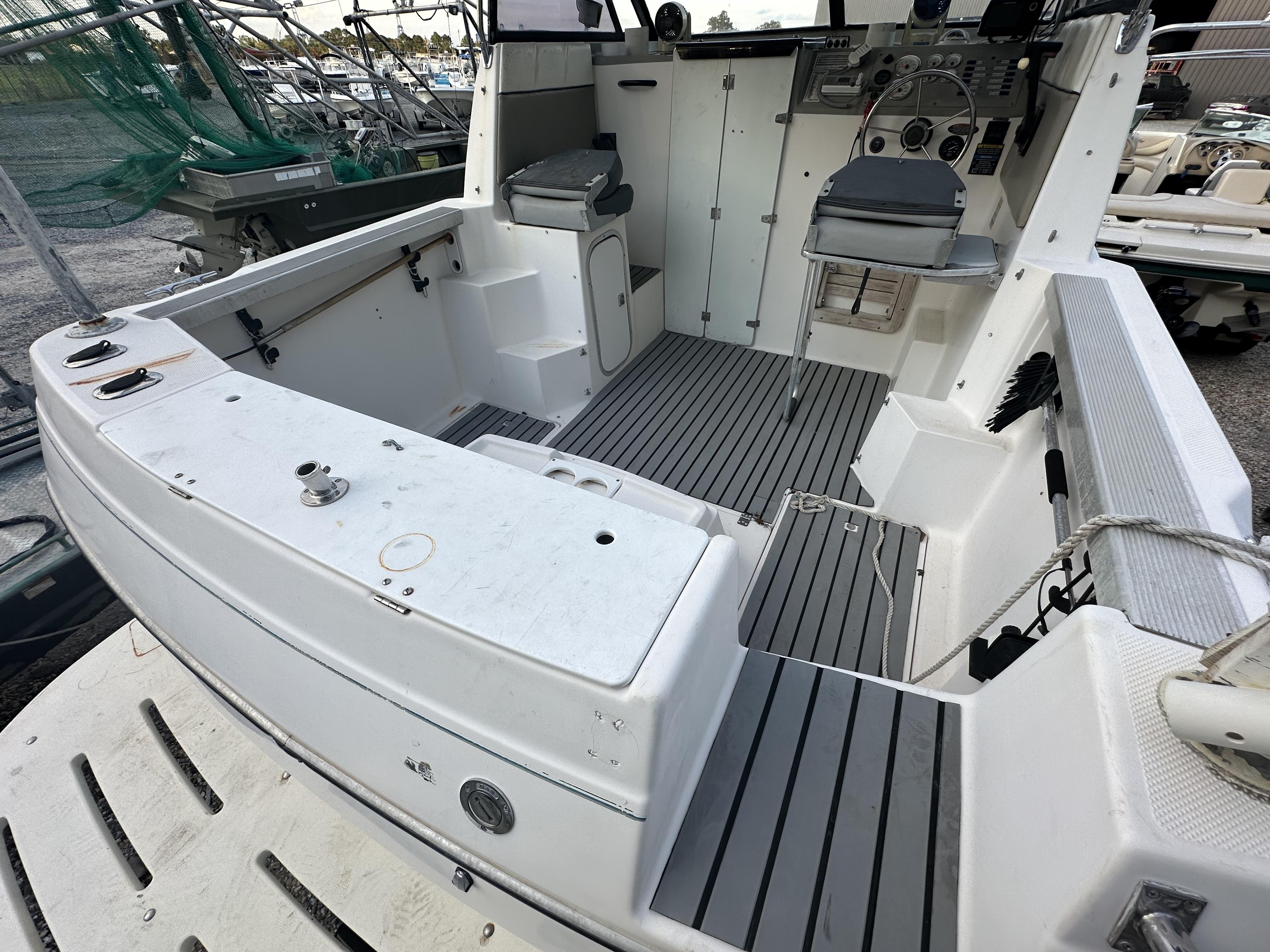 Slide: The Image of 1998 Bayliner 2452 Ciera Express boat interior with seating and control panel. - 2
