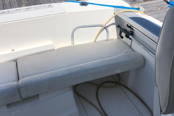 Slide: The Image of 1998 Bayliner 2452 Ciera Express boat interior seating area with white cushions. - 21