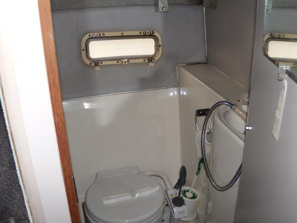 Slide: The Image of 1988 Bayliner 2655 Ciera Sunbridge boat bathroom with toilet and porthole window. - 13