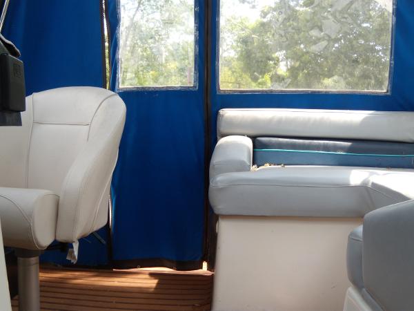 Slide: The Image of Interior of 1988 Bayliner 2655 Ciera Sunbridge with blue and white seating. - 14