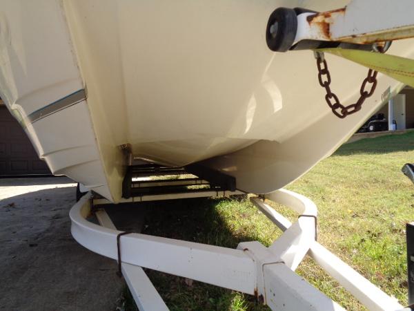 Slide: The Image of 1998 Bayliner 2659 Rendezvous boat on a white trailer, viewed from below. - 1