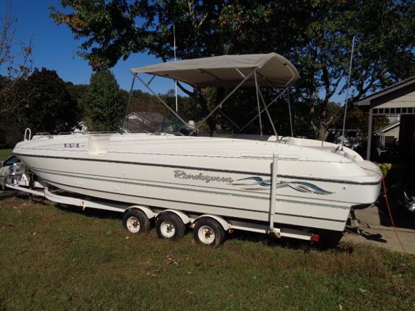Slide: The Image of 1998 Bayliner 2659 Rendezvous boat on a trailer in a grassy yard. - 3