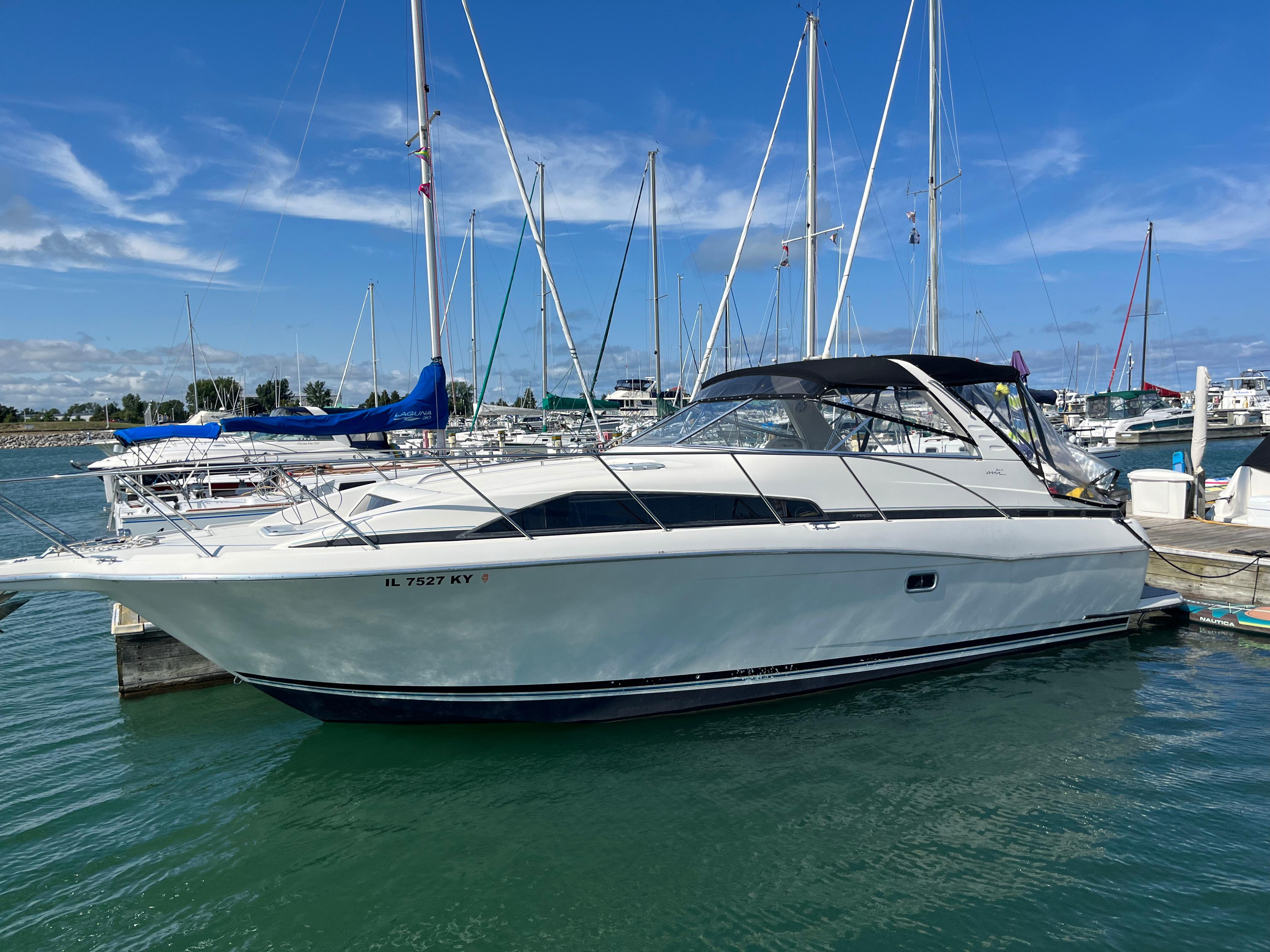 Slide: The Image of 1996 Bayliner 32 Avante docked at a marina on a sunny day. - 0