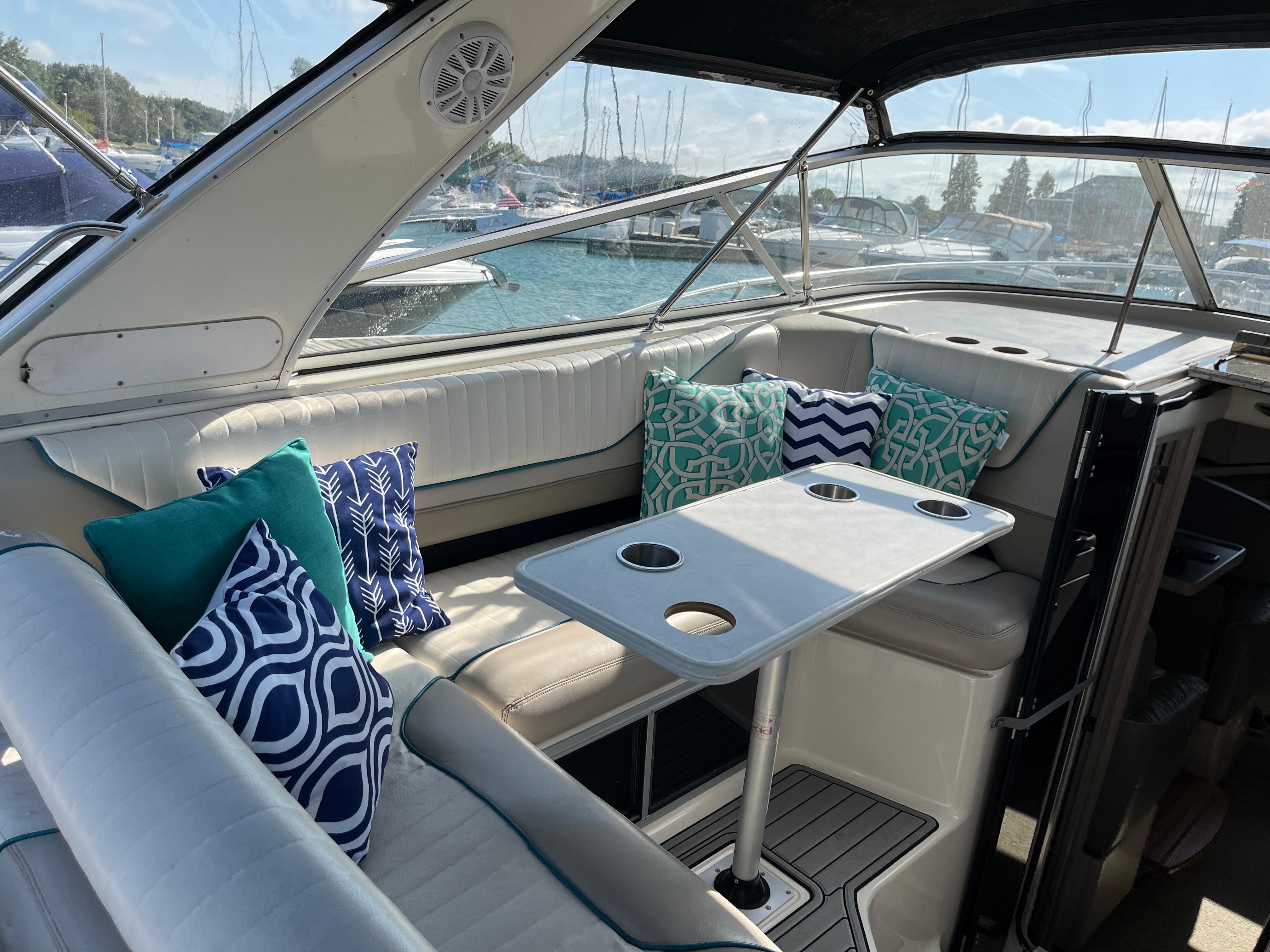 Slide: The Image of 1996 Bayliner 32 Avante interior with cushioned seating and decorative pillows. - 1