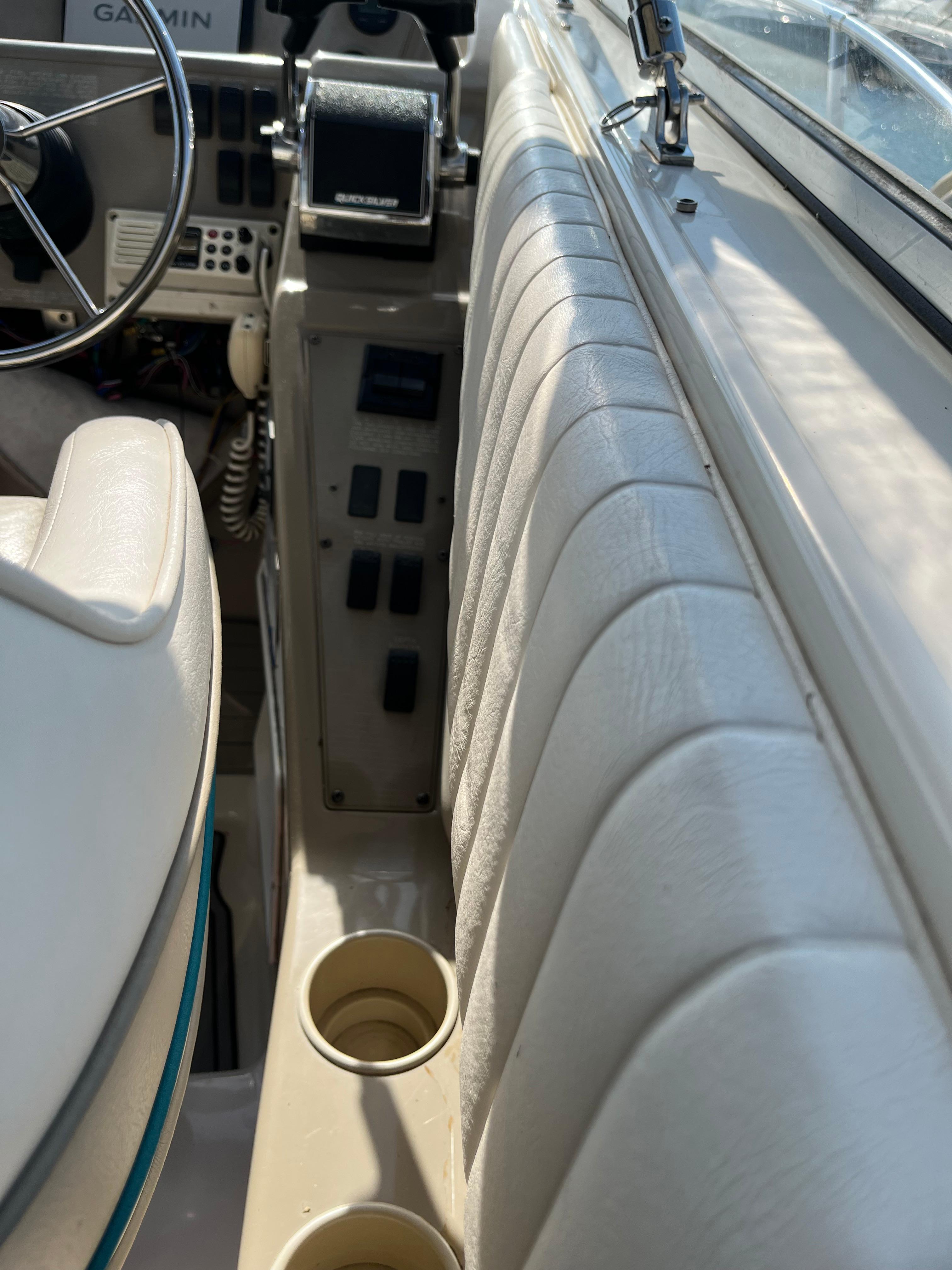 Slide: The Image of Interior cockpit of a 1996 Bayliner 32 Avante boat with steering wheel and controls. - 12